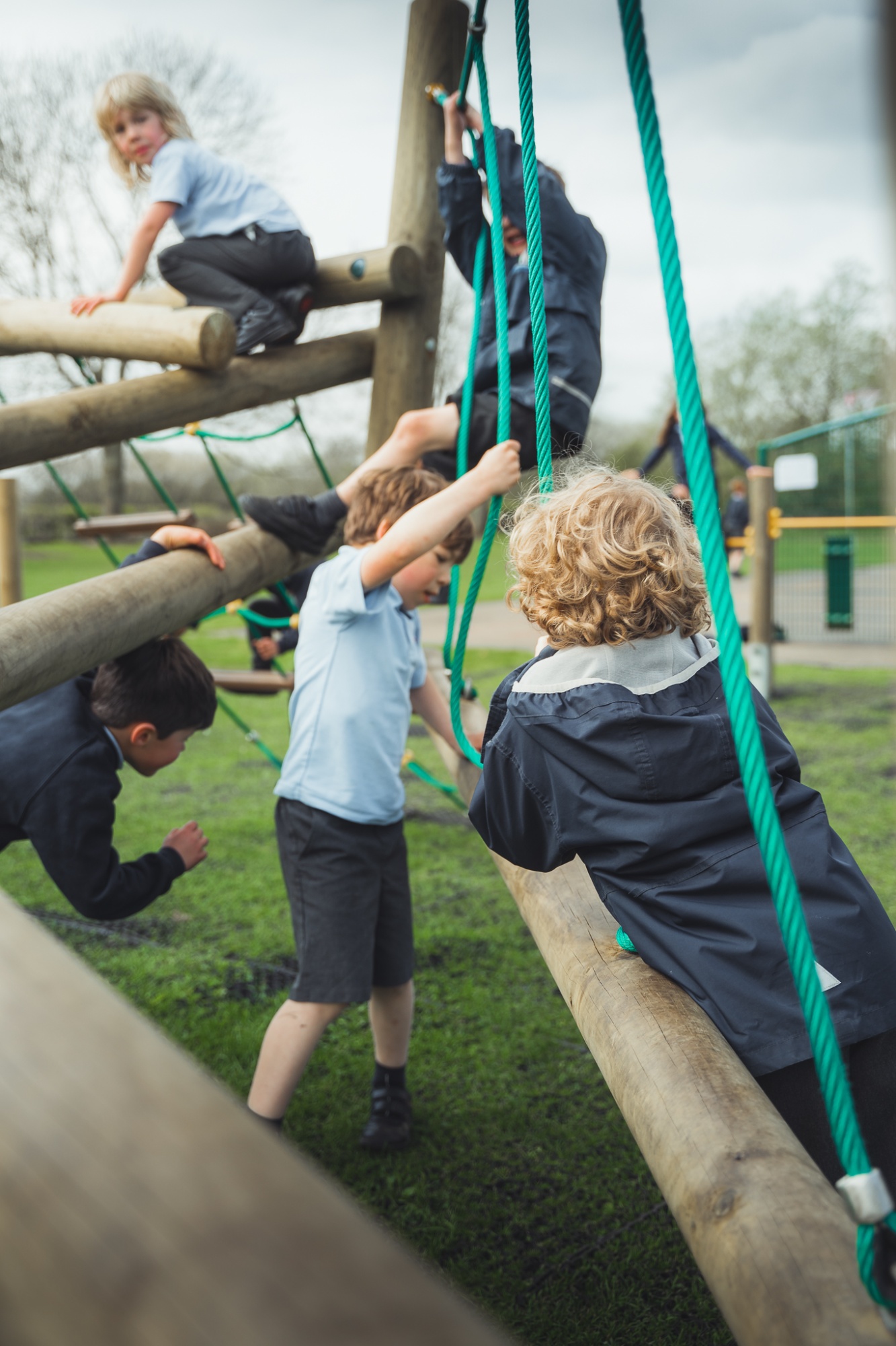 students playing on climbing apparatus