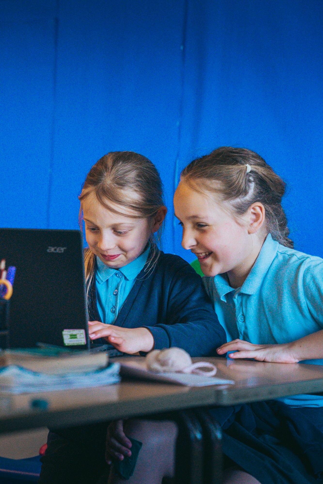 students smiling while in IT lesson