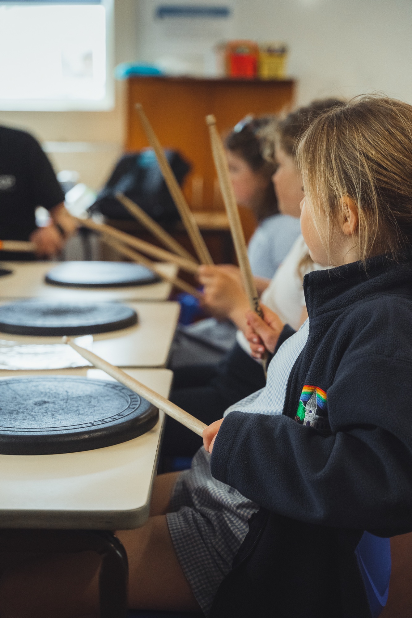 students in a drumming lesson