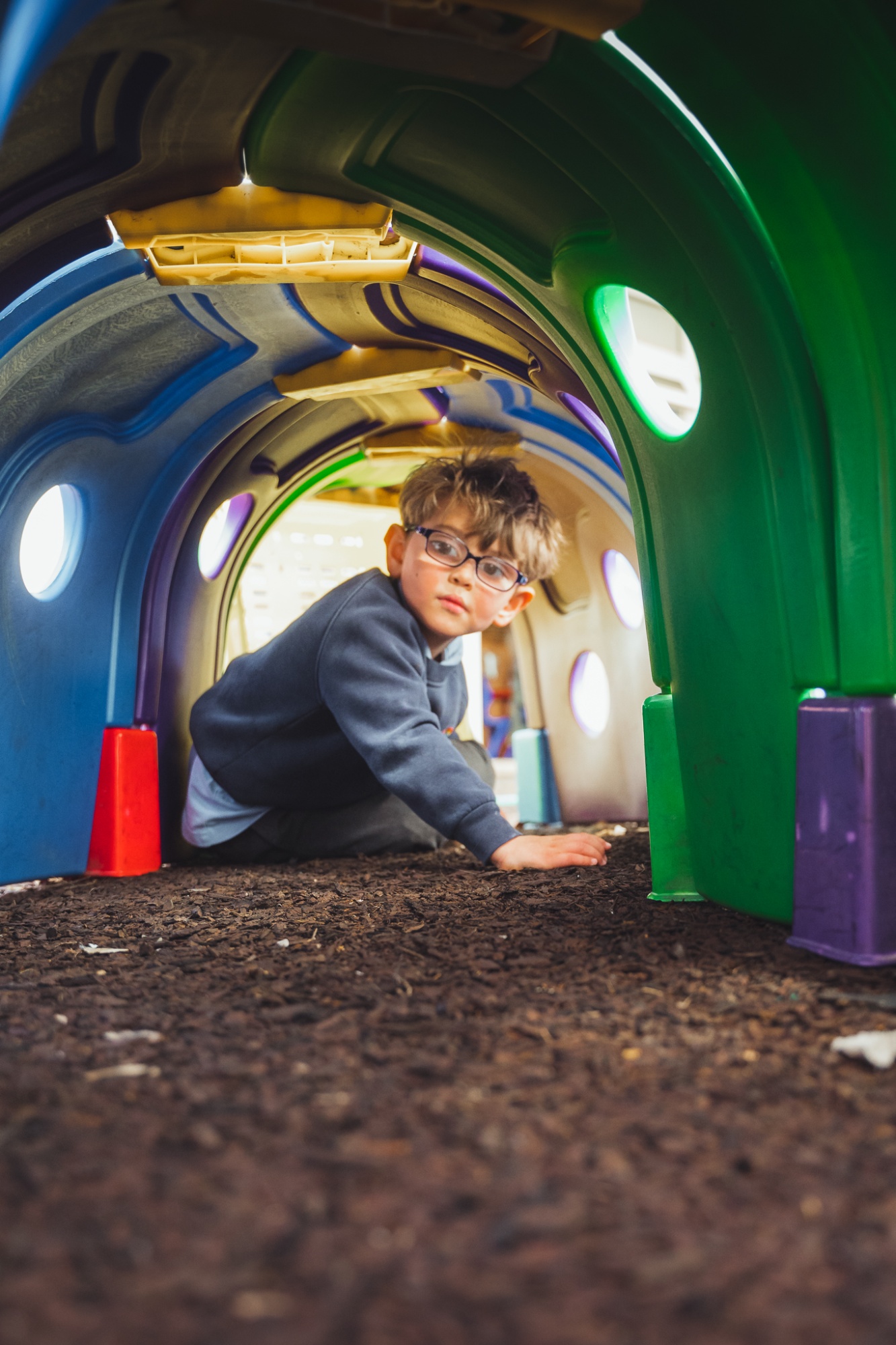 student playing in outdoor apparatus