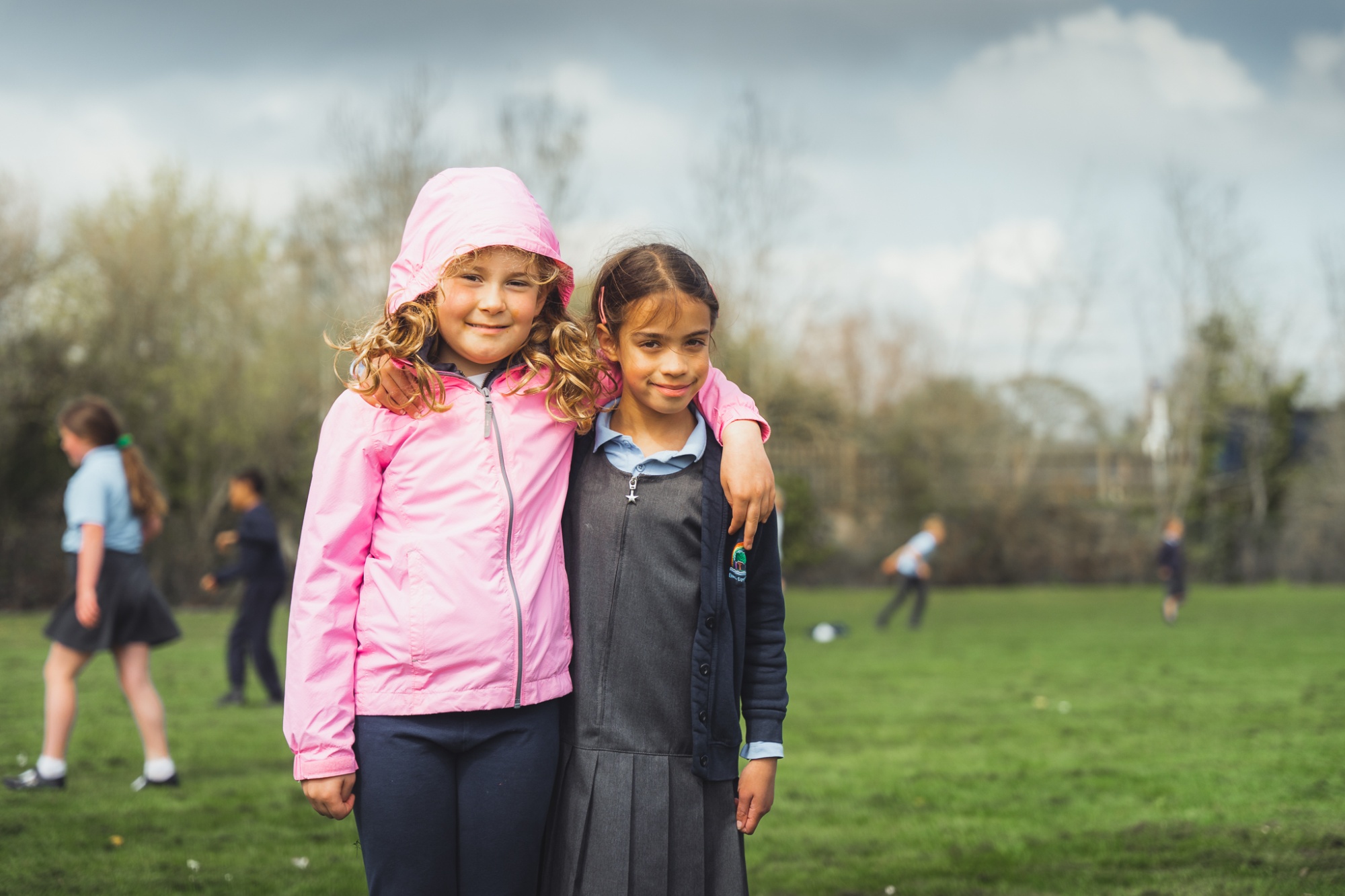 two students smiling at the camera at break time