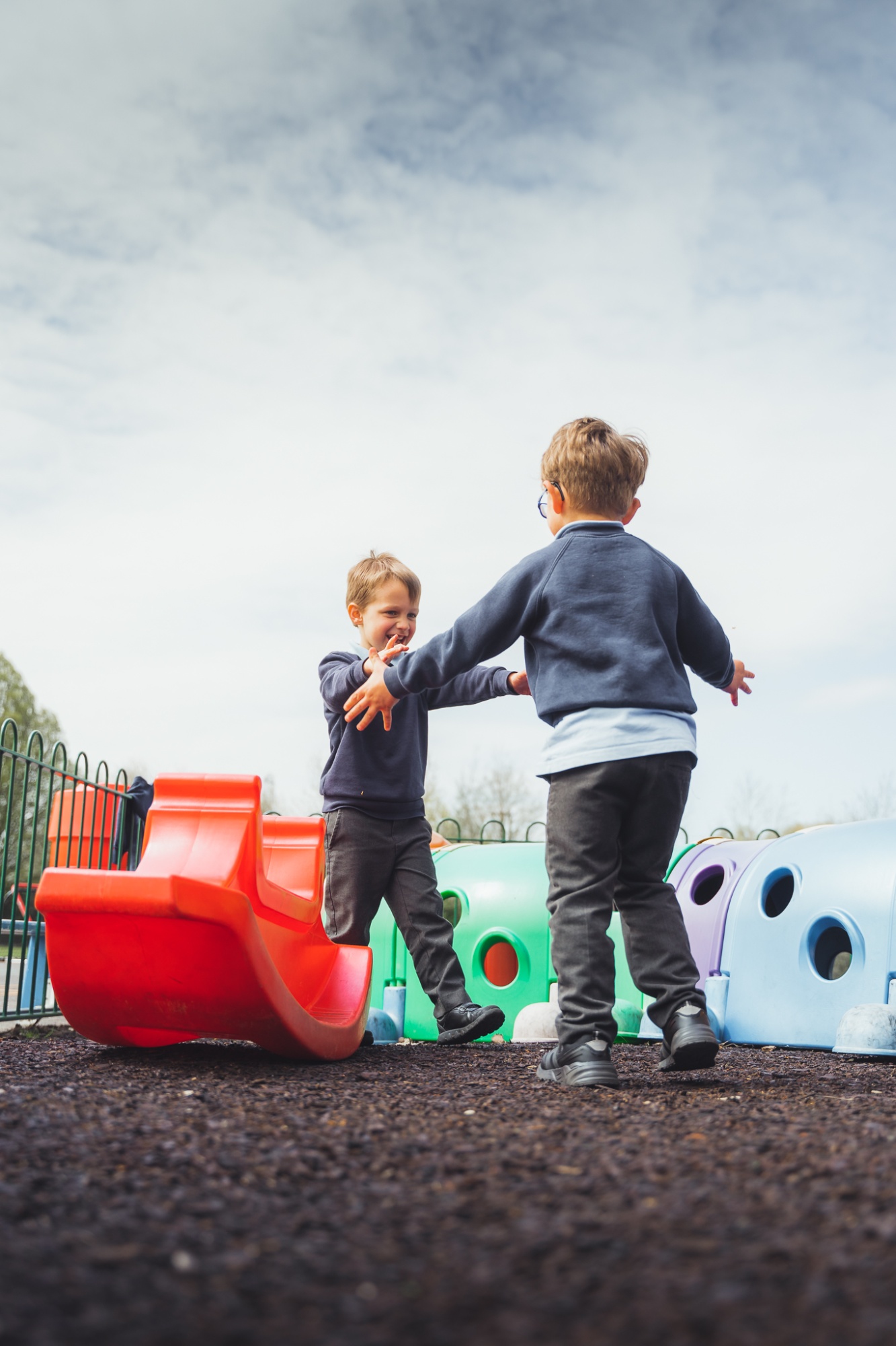 two students on outdoor apparatus